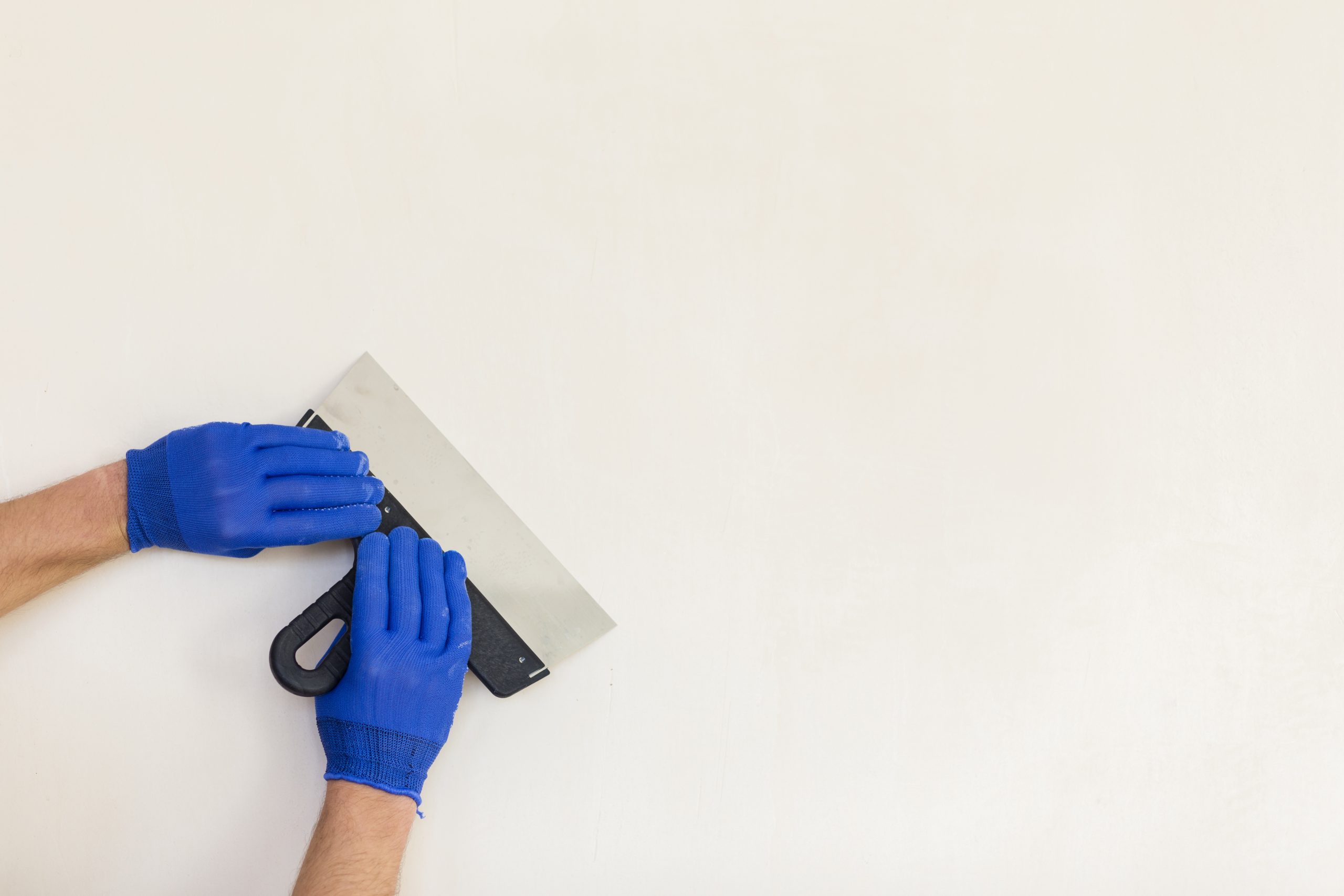 hands-holding-trowel-with-copy-space stucco final inspection