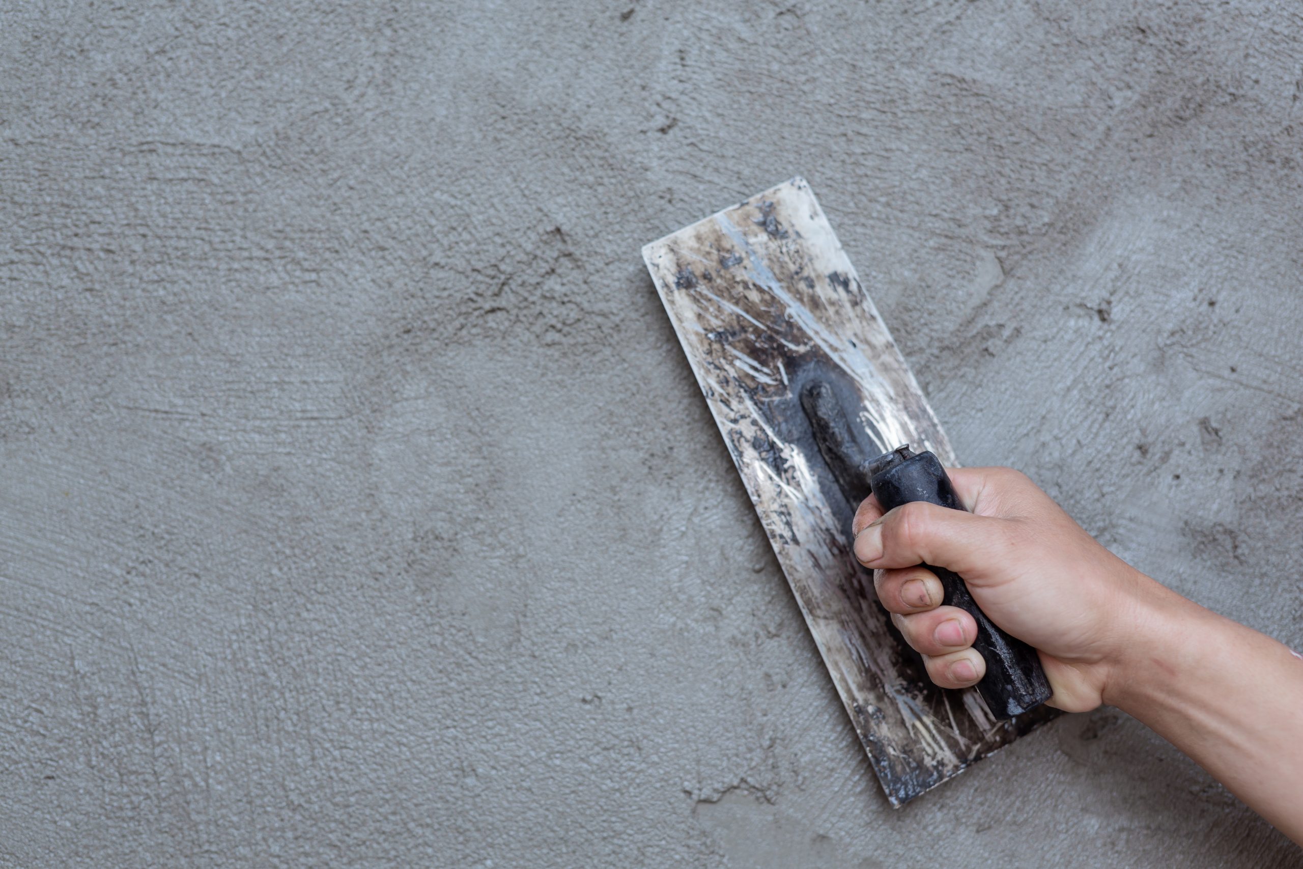 Plasterer renovating indoor walls. stucco repair