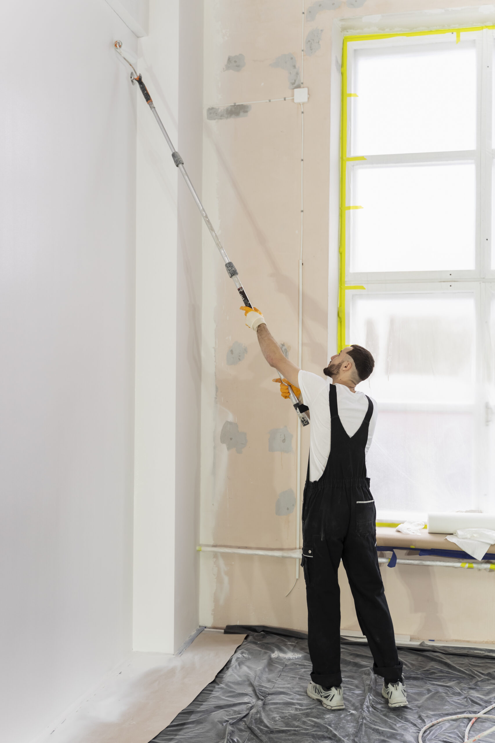 full-shot-young-man-painting-wall professionals painting service nanaimo